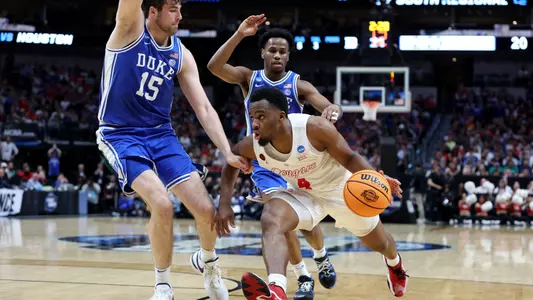 Mar 29, 2024; Dallas, TX, USA; Houston Cougars guard L.J. Cryer (4) drives against Duke Blue Devils center Ryan Young (15) during the first half in the semifinals of the South Regional of the 2024 NCAA Tournament at American Airlines Center. Mandatory Credit: Tim Heitman-USA TODAY Sports