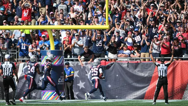 Sep 28, 2025; Foxborough, Massachusetts, USA; New England Patriots cornerback Marcus Jones (25) returns a punt for a touchdown during the first half against the Carolina Panthers at Gillette Stadium. Mandatory Credit: Bob DeChiara-Imagn Images