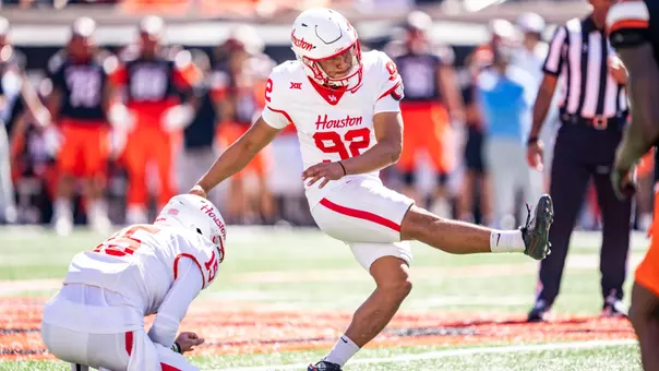 Ethan Sanchez kicking against Oklahoma State