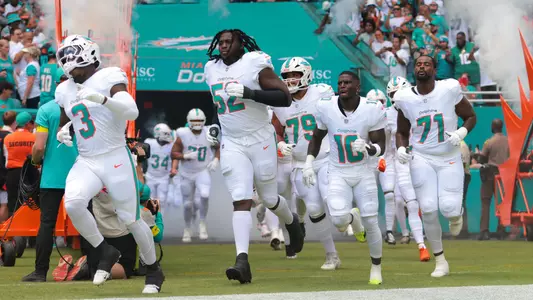 Sep 14, 2025; Miami Gardens, Florida, USA; Miami Dolphins linebacker K.J. Britt (3), offensive tackle Patrick Paul (52), wide receiver Tyreek Hill (10) and offensive tackle Kion Smith (71) take the field against the New England Patriots at Hard Rock Stadium. Mandatory Credit: Sam Navarro-Imagn Images