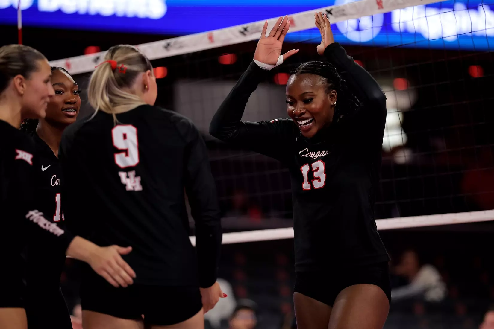 Barakat Rahmon goes to high five Avery Shimaitis after winning a point.