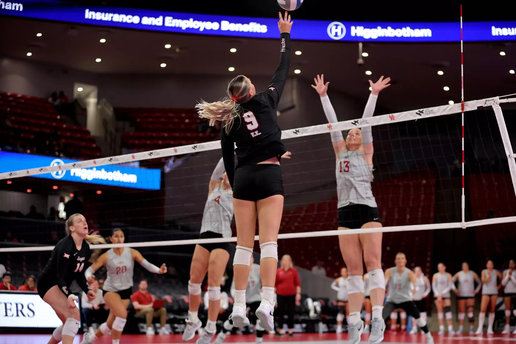 Avery Shimaitis jumps to attack a ball against Iowa State's block.