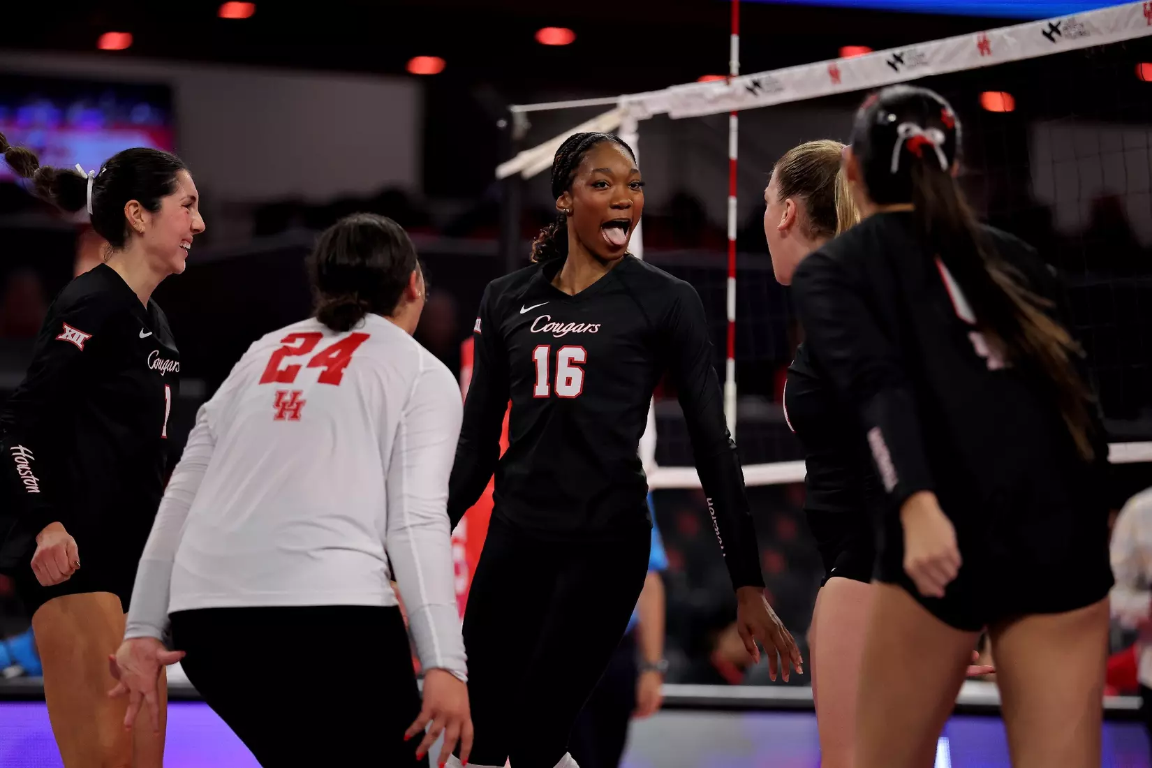 Bre Reid celebrates surrounded by teammates after winning a point.