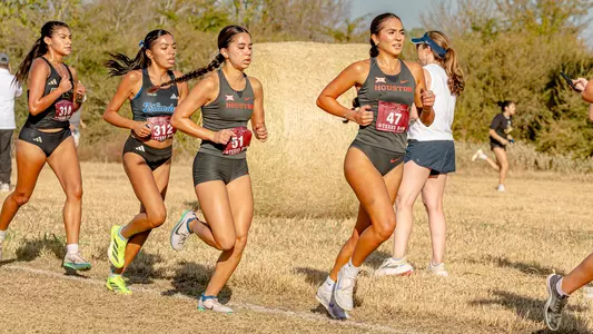 Lily Campos and Sophia Nguyen running at the Big 12 Championship