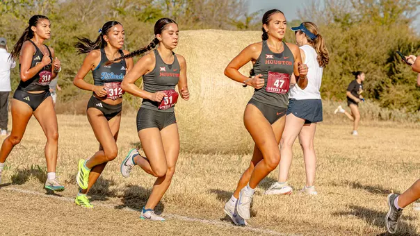 Lily Campos and Sophia Nguyen running at the Big 12 Championship