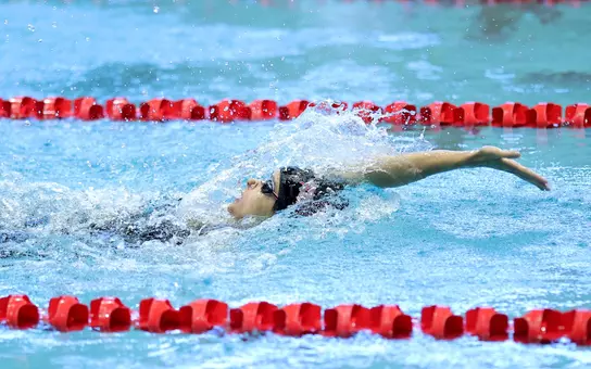 Junior Elizabeth Jimenez swimming the backstroke