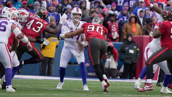 Buffalo Bills quarterback Josh Allen throws a pass straight up the middle while Tampa Bay Buccaneers defensive end Logan Hall heads towards him during second half action against the Tampa Bay Buccaneers on Nov 16, 2025 at Highmark Stadium in Orchard Park.