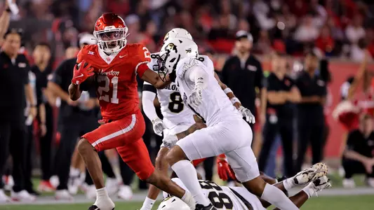 Stacy Sneed stiff arms a Colorado defender