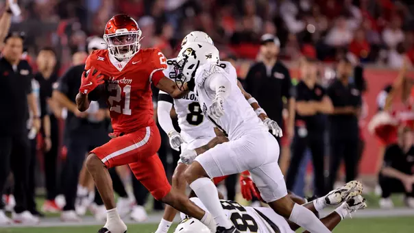 Stacy Sneed stiff arms a Colorado defender