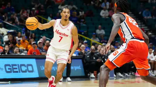 Nov 24, 2025; Las Vegas, Nevada, USA; Houston Cougars guard Milos Uzan (7) drives to the hoop past Syracuse Orange forward William Kyle III (42) during the first half of a 2025 Players Era Festival group play game at MGM Grand Garden Arena. Mandatory Credit: Stephen R. Sylvanie-Imagn Images