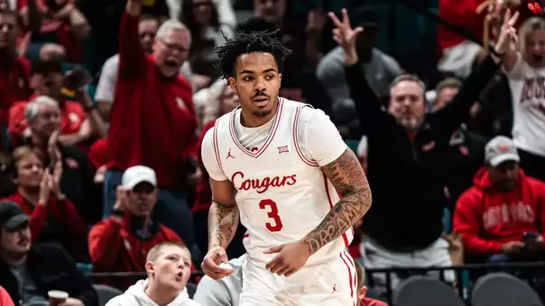 Ramon Walker runs down the court with fans celebrating behind him.