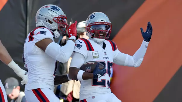 Nov 23, 2025; Cincinnati, Ohio, USA; New England Patriots cornerback Marcus Jones (25) celebrates with teammates after scoring a touchdown during the first half against the Cincinnati Bengals at Paycor Stadium. Mandatory Credit: Joseph Maiorana-Imagn Images