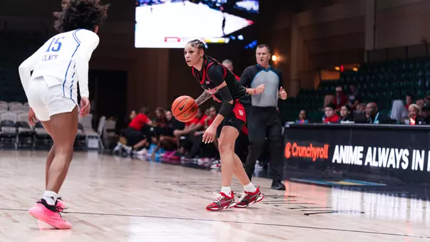 Briana Peguero dribbling basketball with Tulsa defender in front of her