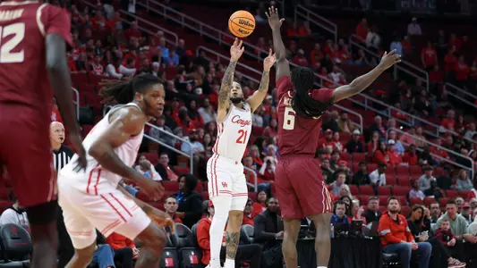 Emanuel Sharp shoots basketball