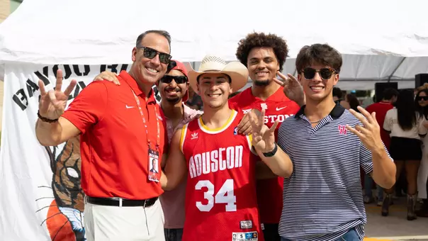 Eddie Nunez with students at tailgate