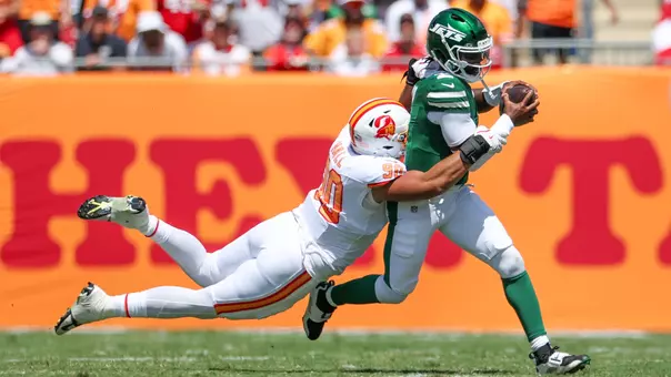 Sep 21, 2025; Tampa, Florida, USA; New York Jets quarterback Tyrod Taylor (2) is brought down by Tampa Bay Buccaneers defensive end Logan Hall (90) in the first quarter at Raymond James Stadium. Mandatory Credit: Nathan Ray Seebeck-Imagn Images