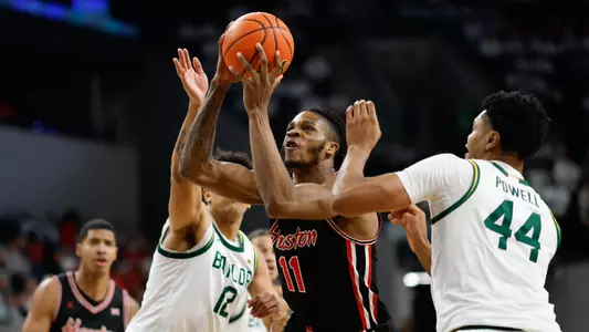 Joseph Tugler holding basketball vs Baylor