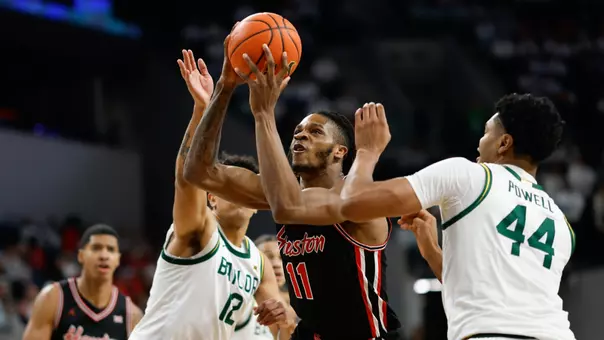 Joseph Tugler holding basketball vs Baylor