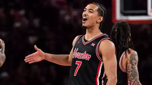 Milos Uzan celebrates