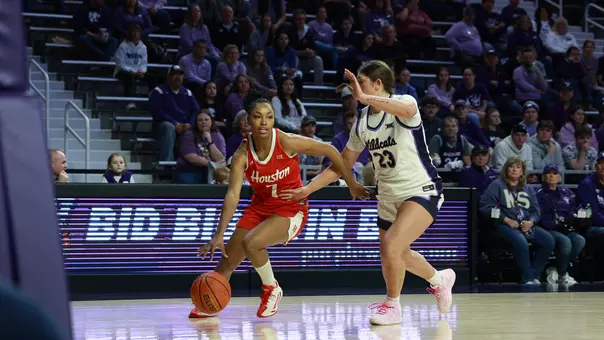 Houston's Kyndall Hunter dribbling ball and Kansas State's Jordan Speiser extending arm into Hunter's waist