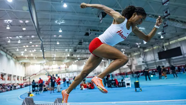 Michaela Mouton running with arms up