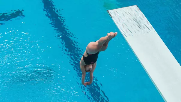 Junior Michelle McLeod diving off the 1-meter springboard at the Big 12 East Showdown