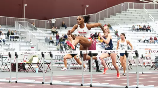 Kaycee McCoy jumping over hurdle at the Ted Nelson Invitational hosted by Texas A&M