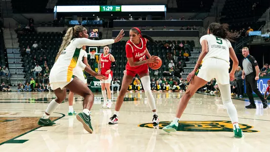Amirah Abdur-Rahim with ball in hand and two Baylor players on both sides