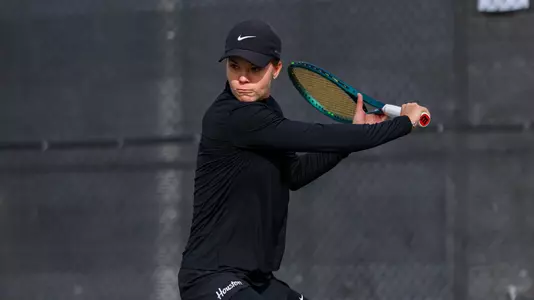 Valeriia Krokhotina swinging a tennis racquet