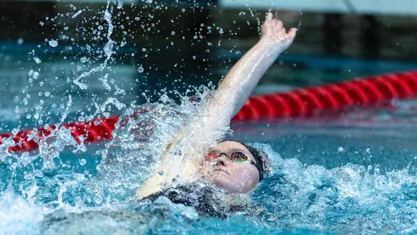 Sophomore Alexia Duncan swimming the backstroke