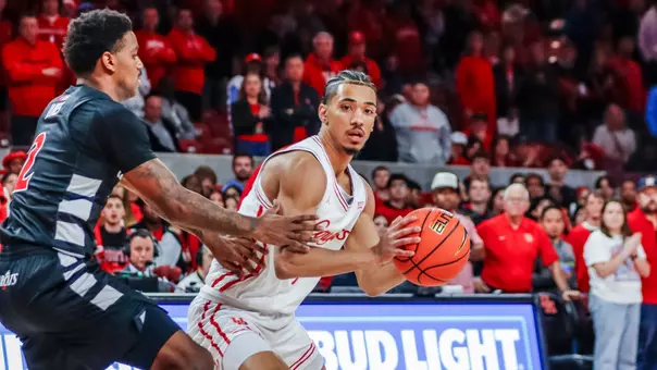 Milos Uzan dribbles with defender
