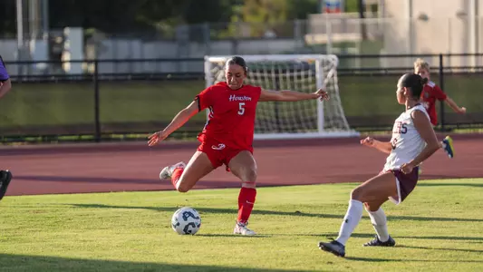 jocelyn chinea kicks a soccer ball