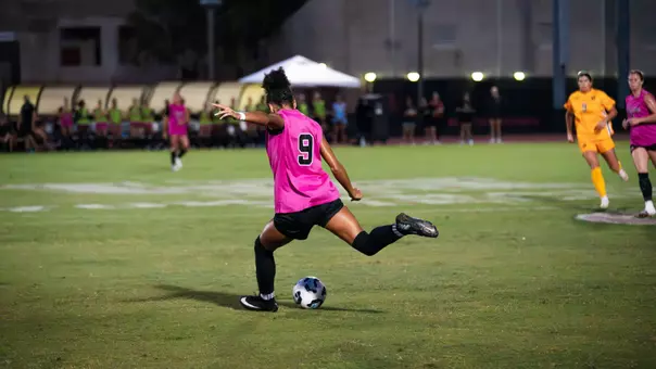Blake Hodgson kicks a soccer ball