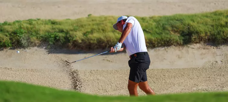 Grant Doggett hits his shot out of the bunker.