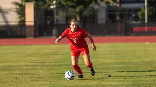 peyton machado kicks a soccer ball