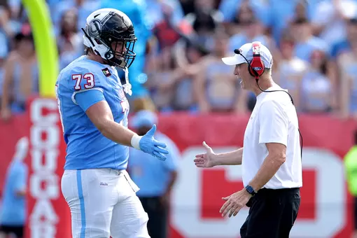 Coach Fritz giving high five to Drew Terrill