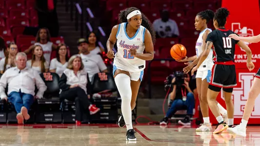 Amani Bartlett running down court with players to her left