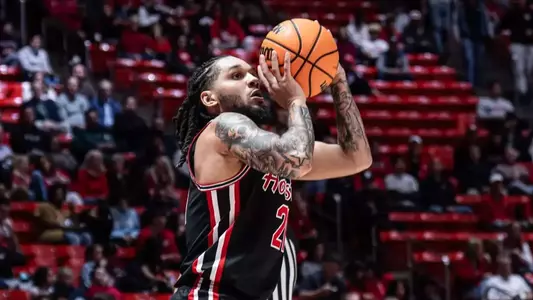 Emanuel Sharp shooting a basketball