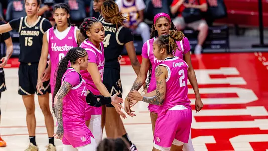 Briana Peguero, Jorynn Ross, Amirah Abdur-Rahim and Kierra Merchant talking in huddle