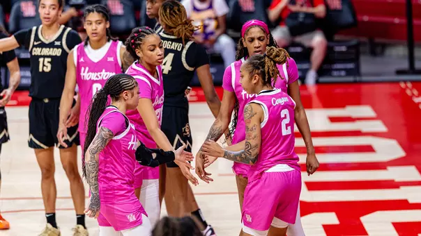 Briana Peguero, Jorynn Ross, Amirah Abdur-Rahim and Kierra Merchant talking in huddle