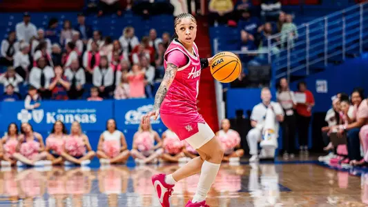 Briana Peguero dribbling ball against Kansas