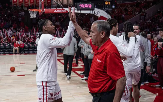 Guard Mercy Miller high fives Coach Kelvin Sampson before game vs. Kansas State inside Fertitta Center