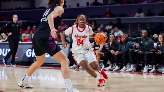 Shun'teria Anumele dribbing ball with TCU defender in front of her