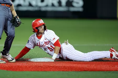 Jackson LaLima looks back after diving into second base.