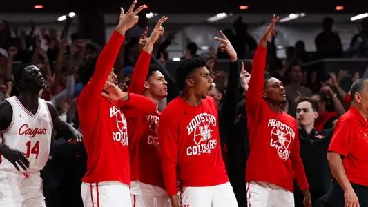 Houston players cheer their teammates from the bench