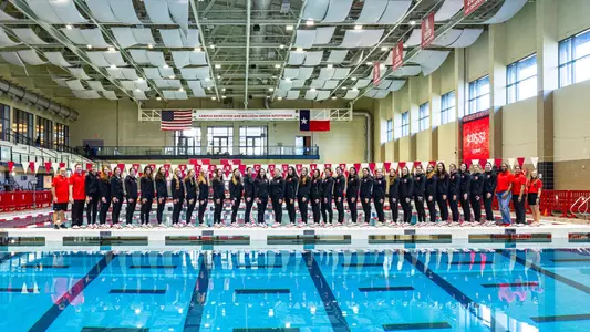 Team photo of the 2025-26 Swimming and Diving Team on the pool deck