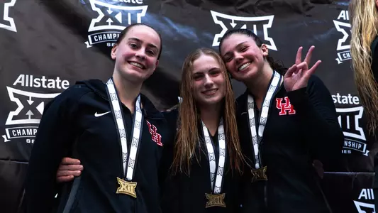 Diving Brings Home Bronze at Big 12 Championship - Divers Michelle McLeod, Maisy Woloszyn and Caroline Roelen pose on the podium with their medals