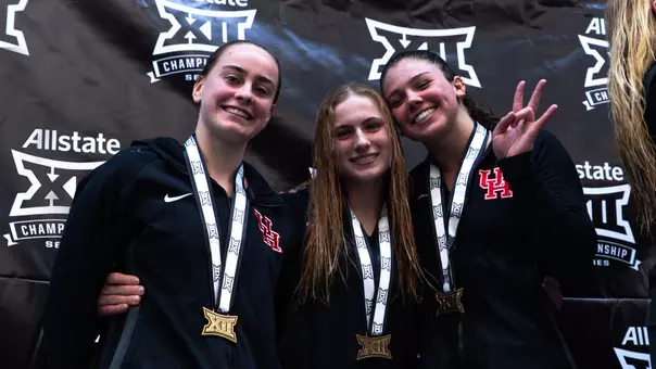 Diving Brings Home Bronze at Big 12 Championship - Divers Michelle McLeod, Maisy Woloszyn and Caroline Roelen pose on the podium with their medals