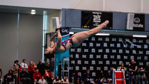 Freshman Maisy Woloszyn diving from the 1-meter springboard at the Big 12 Conference Championships