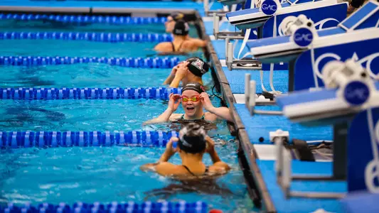 Sophomore Alexia Duncan smiling after winning the 100-yard backstroke at the Big 12 Conference Championships